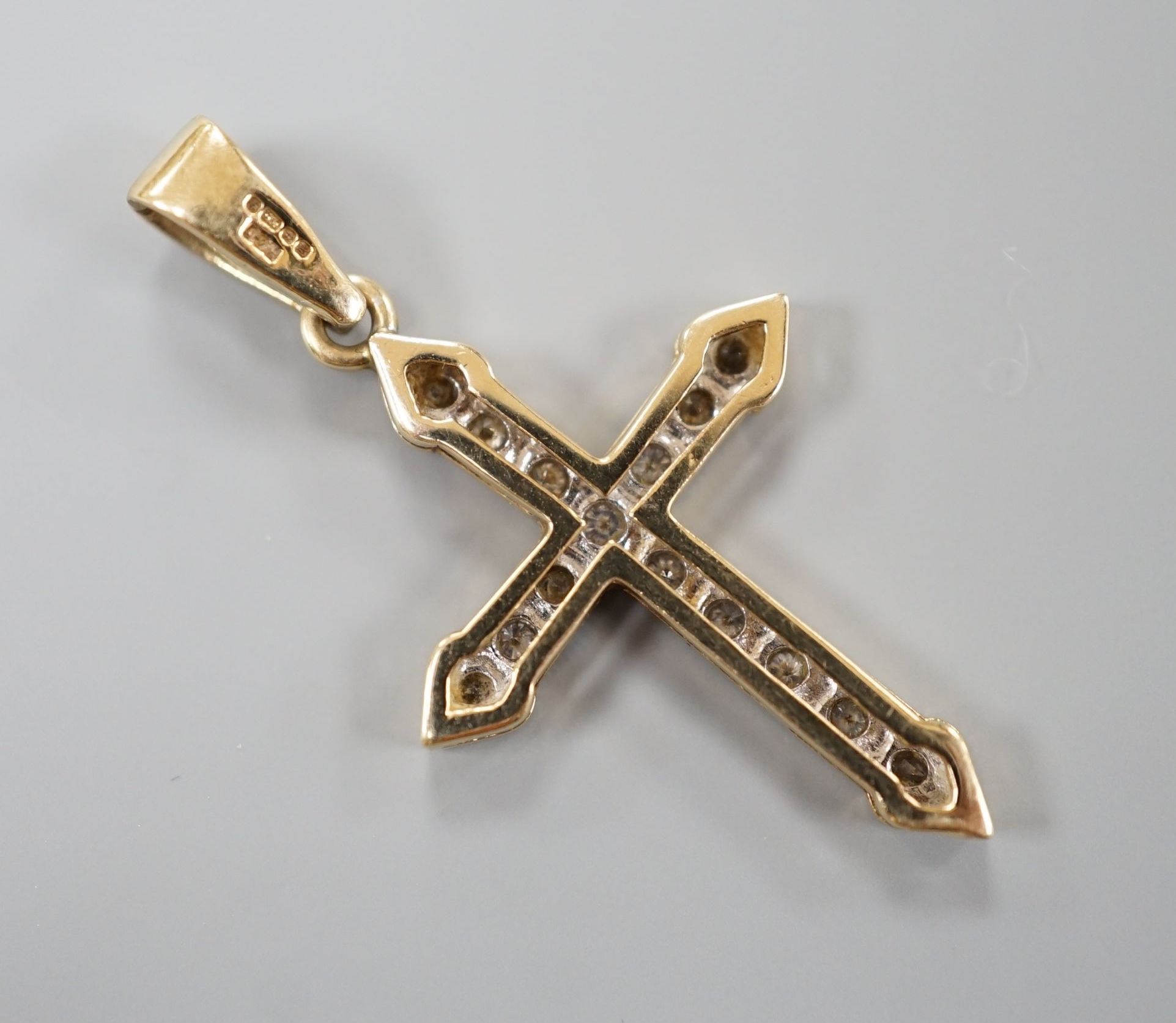 A modern 9ct gold and diamond set cross pendant, overall 4cm, gross weight 3 grams.